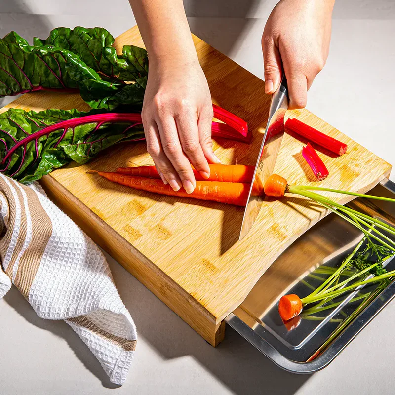Bamboo cutting board with pull-out steel tray